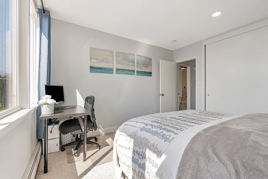 Sizable carpeted bedroom with a big closet