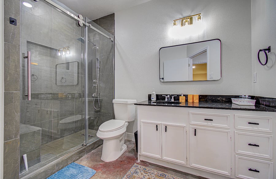 Large bathroom with standing shower, rainhead shower panel, bench,custom vanity