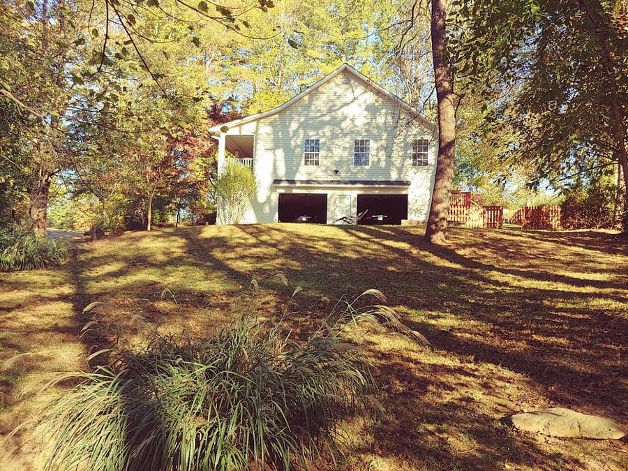 Garage view and the woodsy area adjacent to the property (winter).