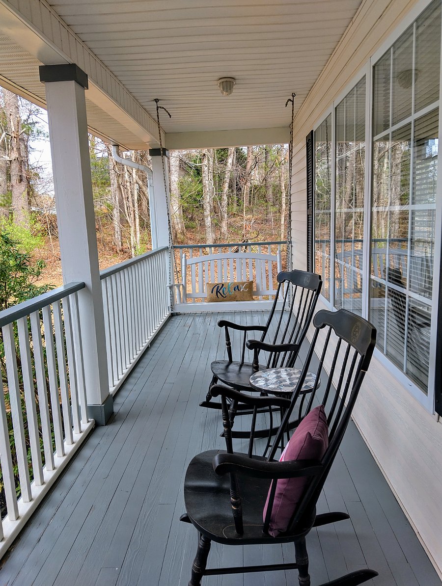 The cozy porch offers a swing and two rocking chairs for your enjoyment.
