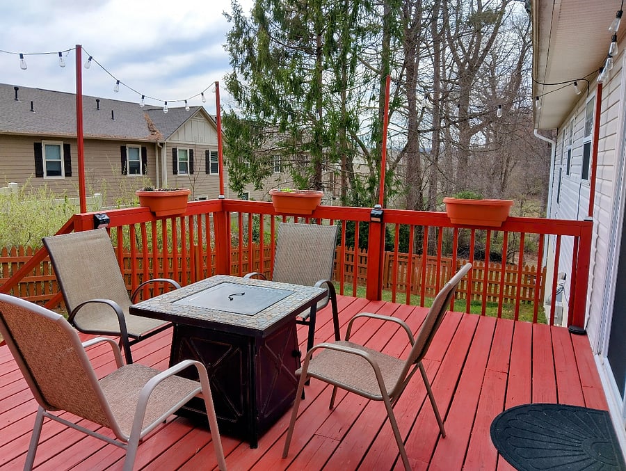Another view of the deck. While there are apartments behind the property, the fence and surrounding trees create a comfortable sense of privacy.
