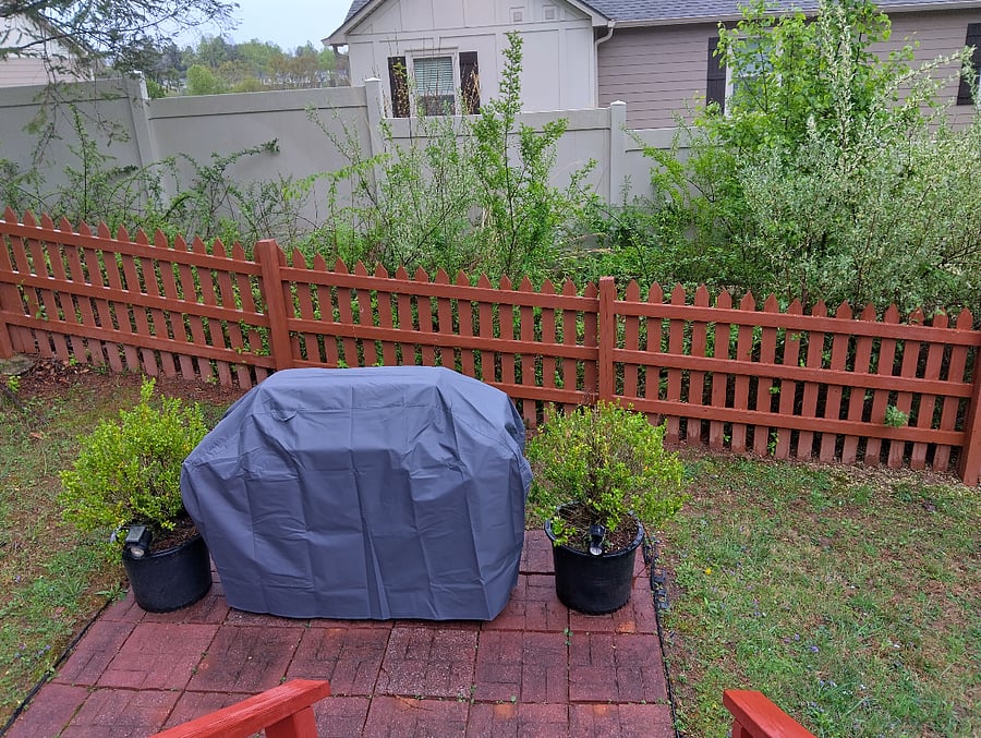 The grill is located in the back yard, right behind the deck for convenience as you move between the kitchen and the deck area.