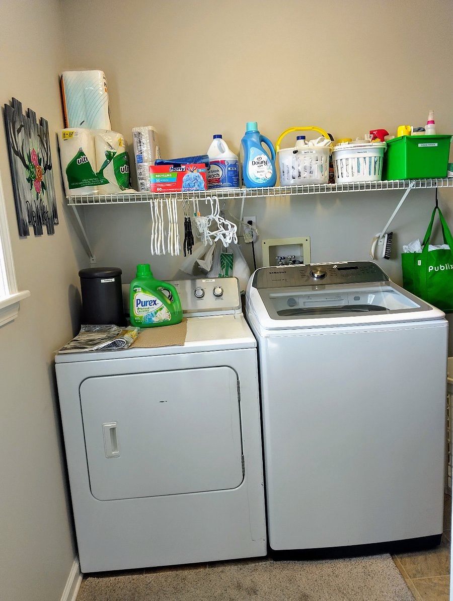 The laundry area is located on the main level next to the pantry, with both spaces combined into one convenient room.