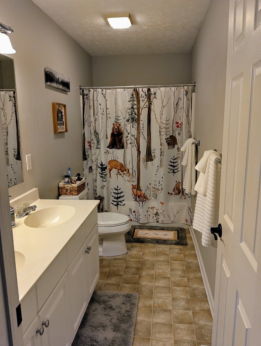 The secondary bathroom is spacious and includes two sinks, offering plenty of room for getting ready.