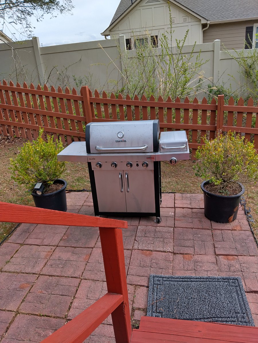 The grill is located in the back yard, right behind the deck for convenience as you move between the kitchen and the deck area.