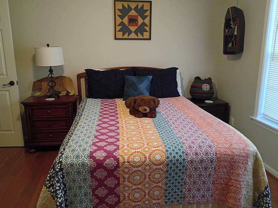 The third bedroom, known as the Bear Room, features a queen-size bed and a chest of drawers.