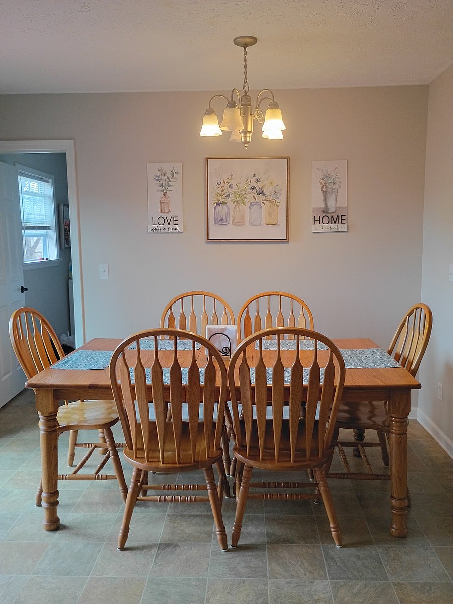 The dining area is conveniently located next to the kitchen, with seating for six. From here, you can easily access the laundry and pantry area.