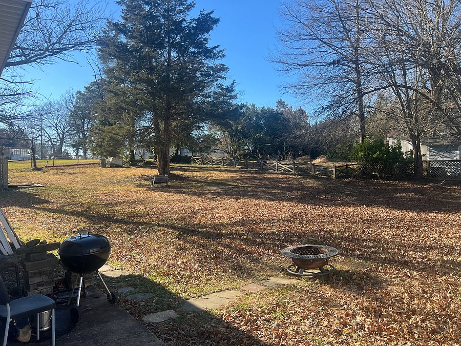 Backyard, with fire pit and charcoal grill.