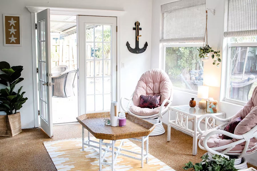 Bright sunroom with comfortable seating, perfect for morning coffee, relaxing with a book, or enjoying natural light throughout the day.