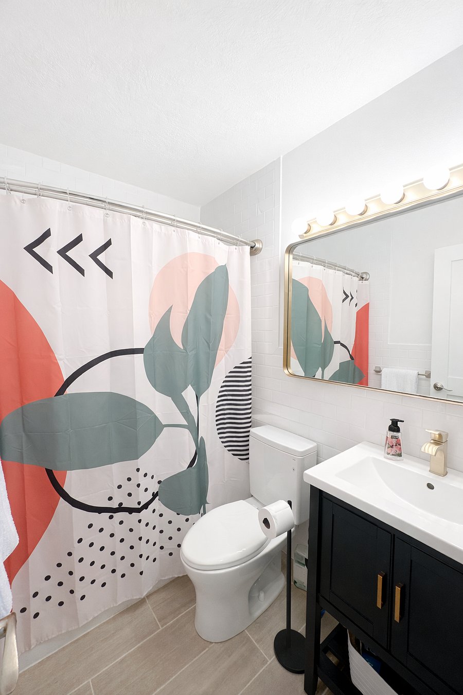 Bright guest bathroom with a shower tub combo, modern vanity, and fresh, clean design for everyday comfort and convenience.