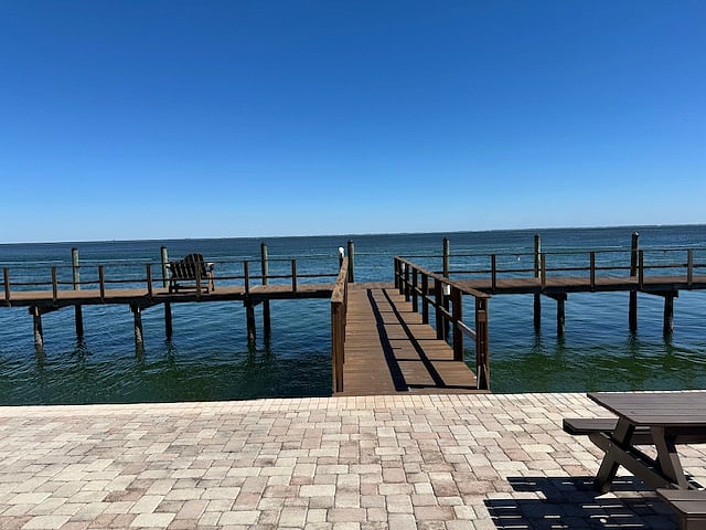 Fishing and sunset pier at Yacht Club on Tampa Bay with view of Skyway Bridge