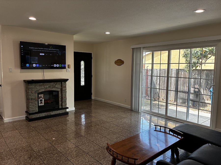 The living room includes an electric fireplace, with heat, and a Samsung 55 inch Smart TV. With the provided HDMI cable, you can connect devices or game consoles with ease. Next to the sofa, there is extra space for a table if youd like