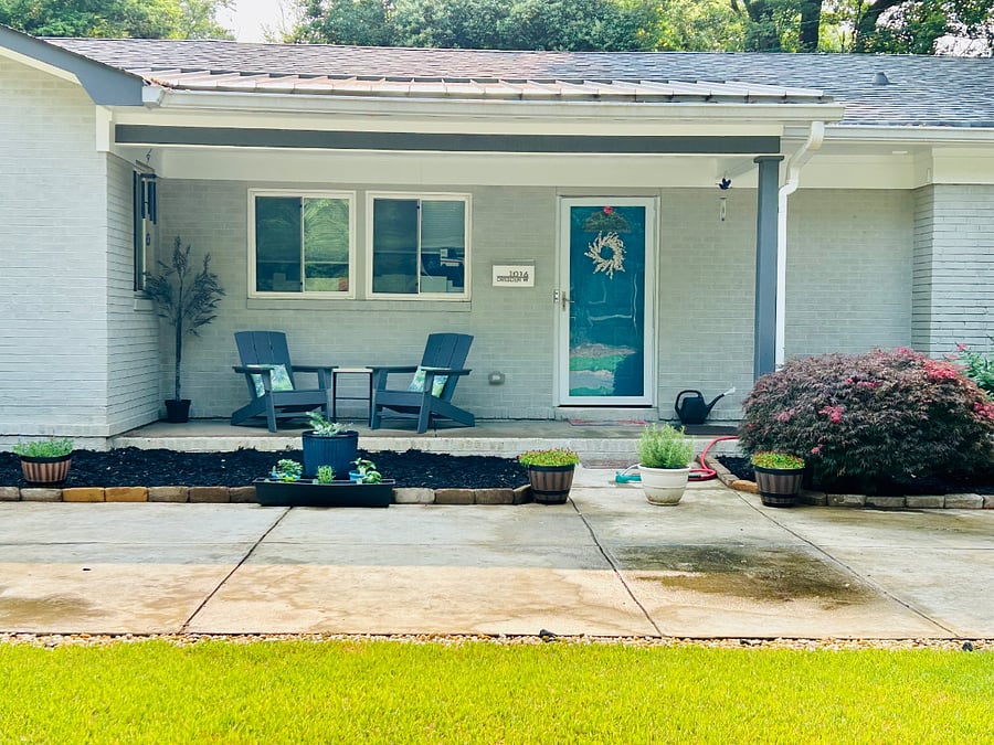 Charming front porch with inviting seating, provides the perfect spot to enjoy a cup of coffee or a glass of wine.