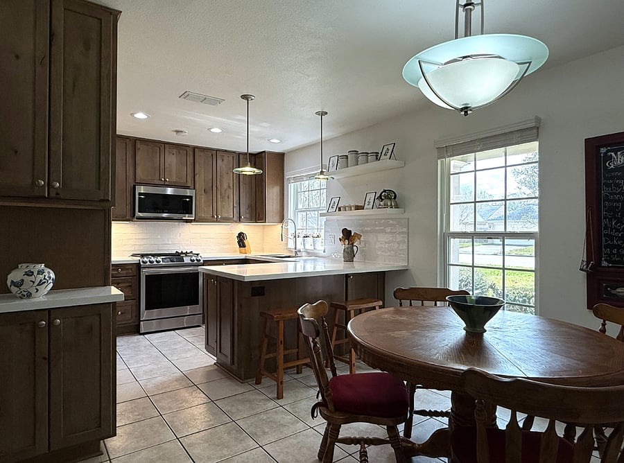 Shared kitchen with modern appliances, dining area, and a comfortable setup for light cooking.