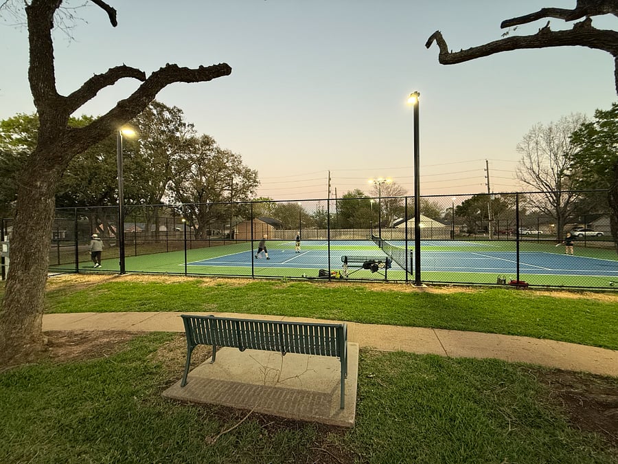 Community park and outdoor recreation areas nearby featuring sidewalks, seating benches, and relaxing green spaces.