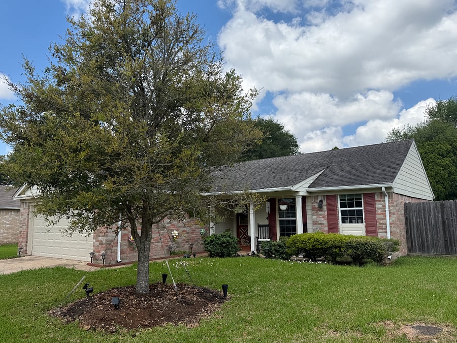 Welcoming exterior with mature trees and a quiet residential atmosphere.