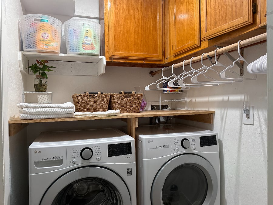 Clean and organized laundry area with full-size washer and dryer, folding space, and convenient touches for a comfortable stay.