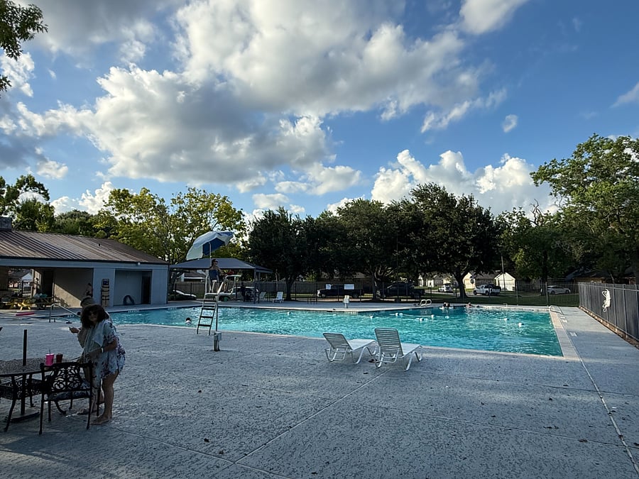 Private community recreation area featuring a large swimming pool and a separate children's pool