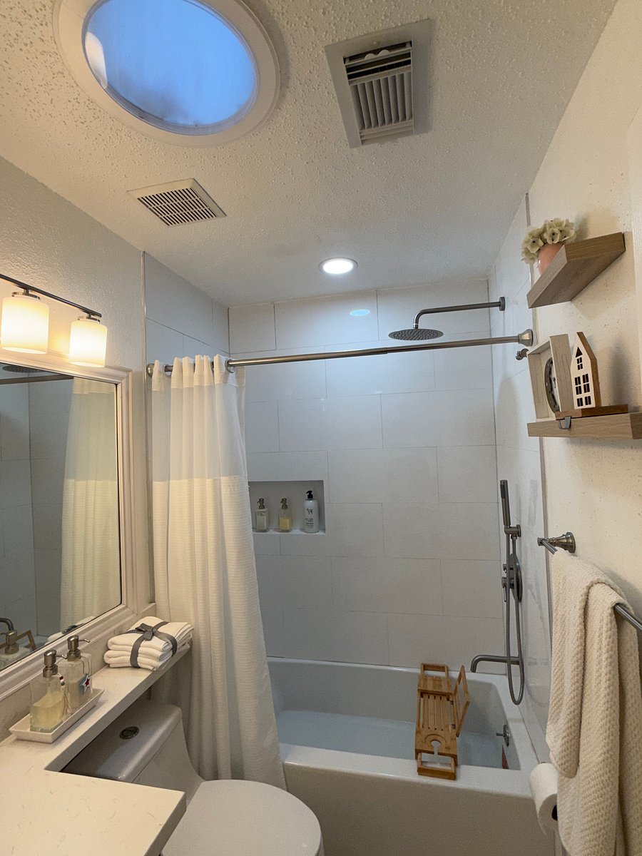 Resident-ready bathroom with fresh towels, shampoo, hand soap, lotion, toilet paper, bath mat, and essential bathroom supplies provided