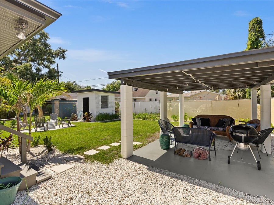 Back yard amenities include ample back yard space, covered lanai with seating and grill, and chairs for relaxation or to enjoy the fire pit.