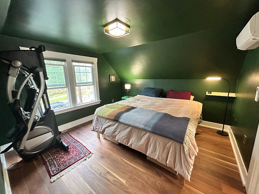 Primary bedroom. Elliptical exercise machine shown folded up.