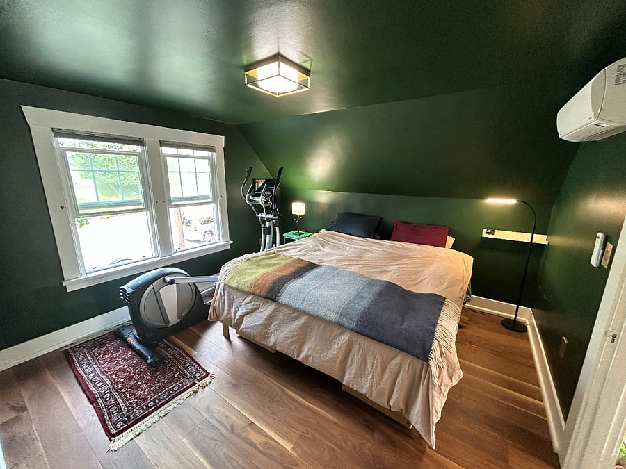 Primary bedroom. Elliptical exercise machine shown folded down.