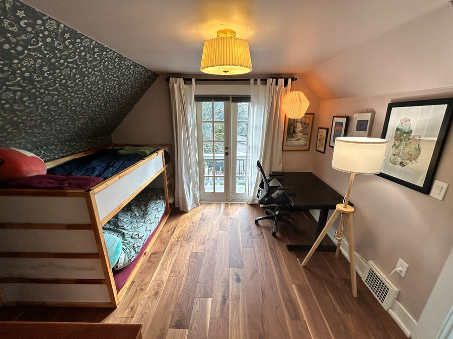 Second bedroom. Current setup is for children's bedroom + office. Furniture can be moved or removed to fit needs of renter. French doors lead out to balcony.