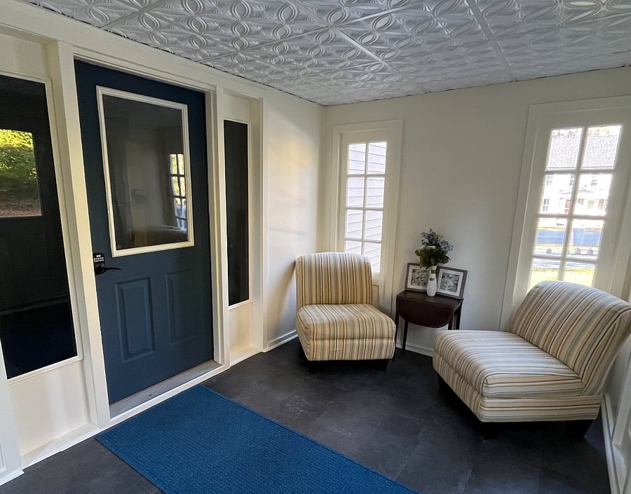 Vestibule entrance to building with code locked door, motion sensor security lighting both inside and outside