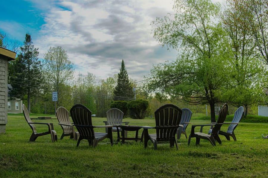 Fire pit in back yard with plenty of seating.