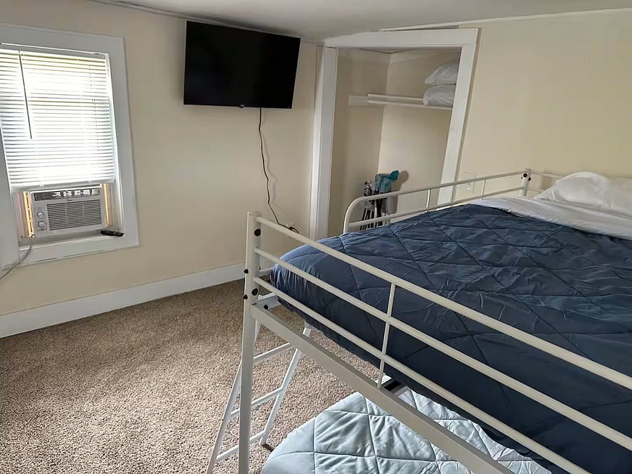 Bedroom currently arranged with bunk beds for short-term stays; can be reconfigured with queen beds for mid-term guests.