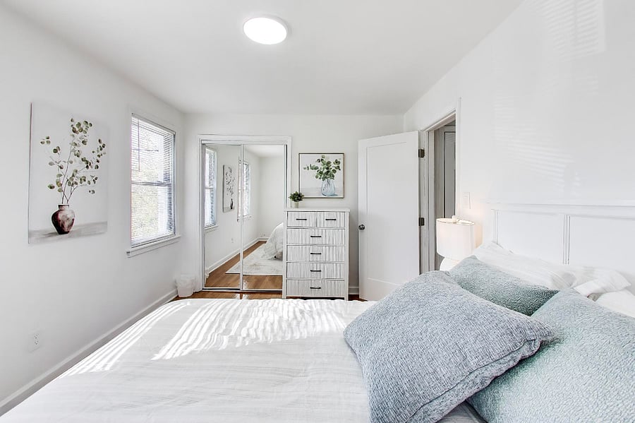 Primary Bedroom with Queen Bed and mirrored closet doors