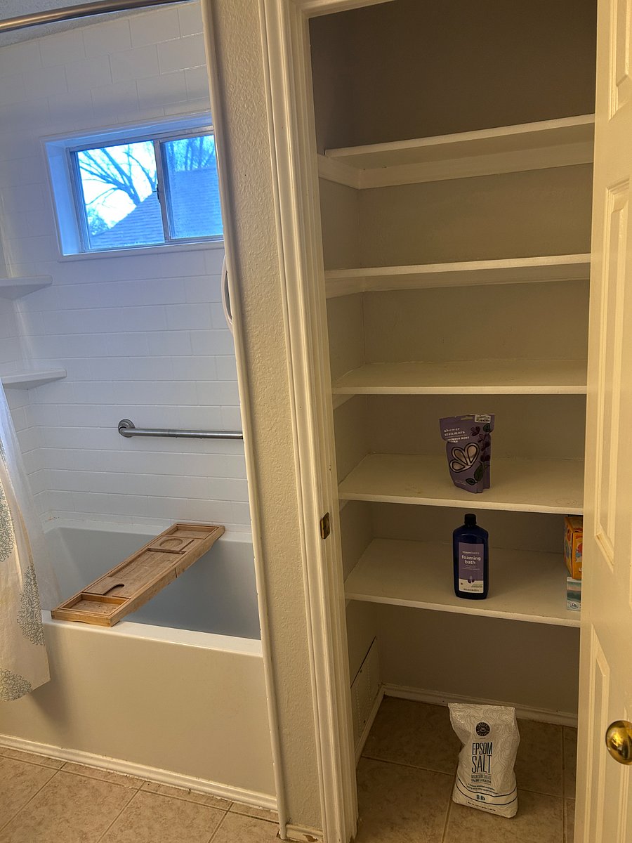 Primary bathroom closet--lots of deep shelves!