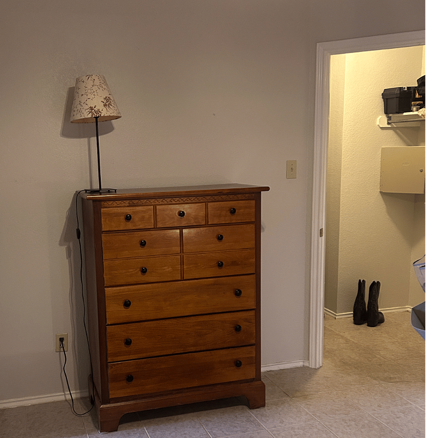 Dresser in primary bedroom next to walk-in closet