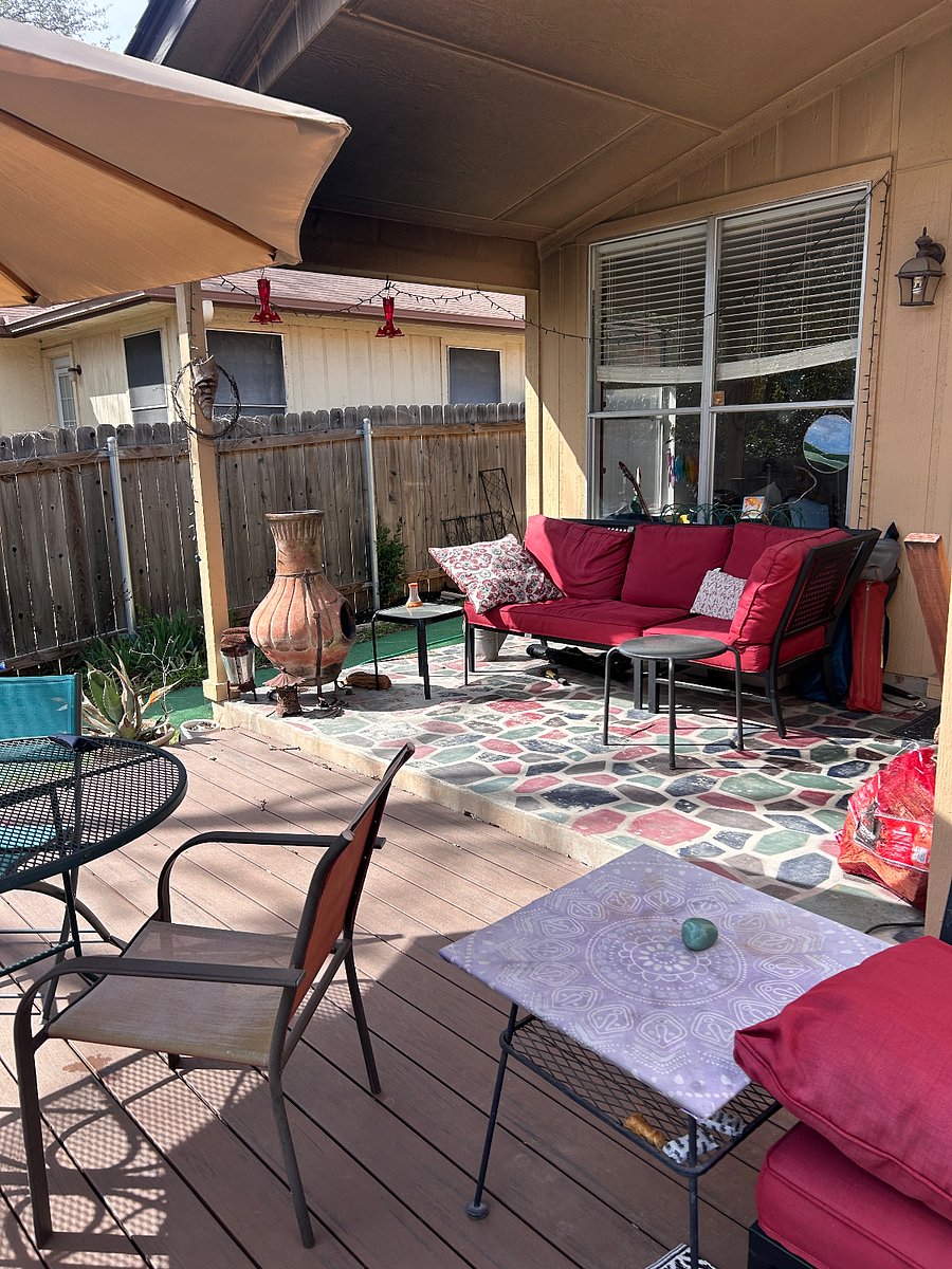 Lovely patio with lots of comfortable seating and a large table with shade umbrella