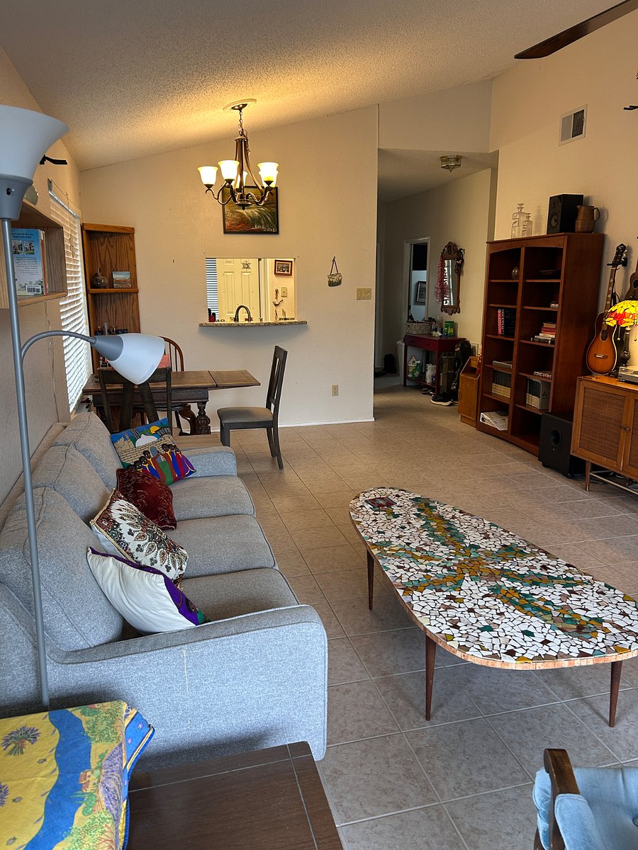 Living room has a comfy couch, unique coffee table, and expandable dining table!