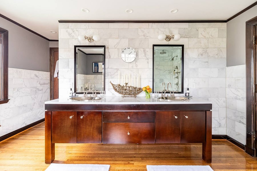 The marble ensuite master bath includes an antique copper tub, double sink vanity and marble tiled luxury shower.