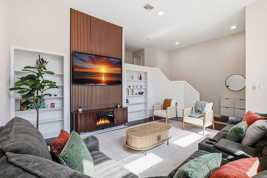Living room with a large recliner couch for 7 people + 2 accent chairs. 75 smart TV and board games for your couch potato days.