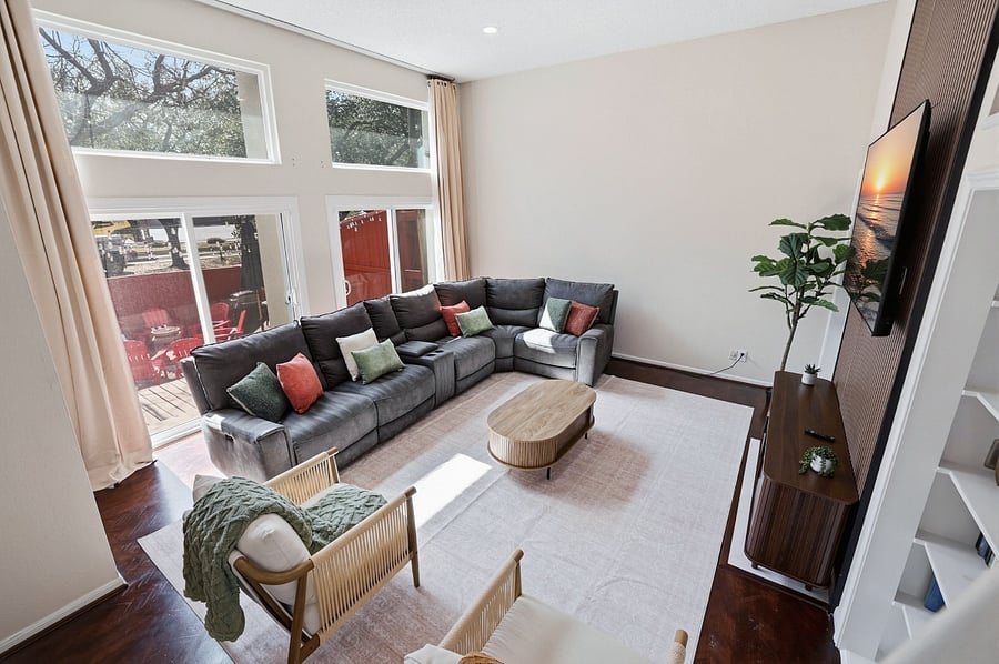 Living room with a large recliner couch for 7 people + 2 accent chairs. 75 smart TV and board games for your couch potato days.