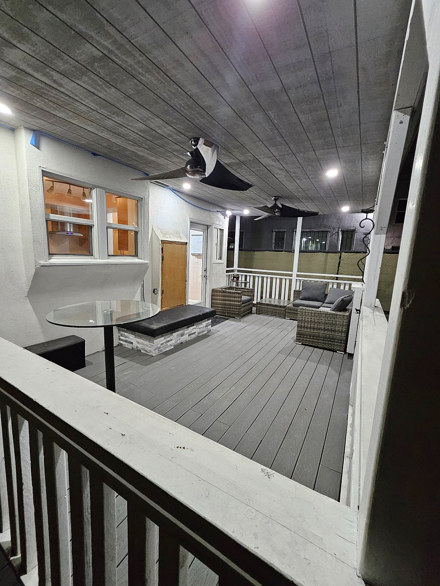 Large private back porch with ceiling fans and dimmable recessed lights