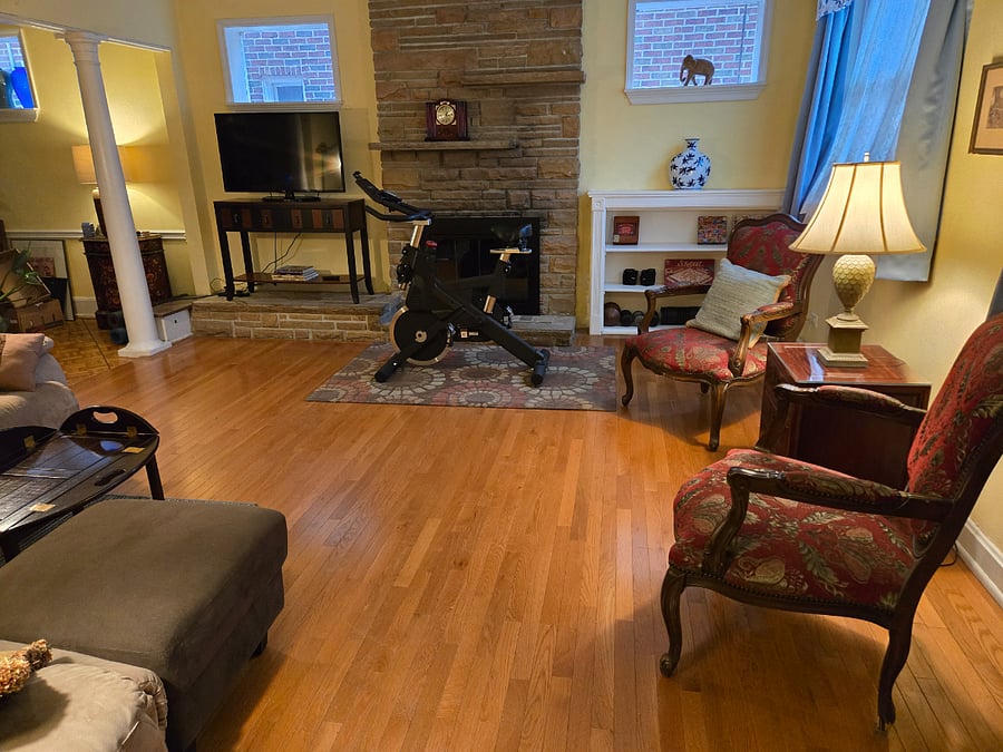 Exercise bike and lots of seating in shared living room. Fireplace is non-functional.