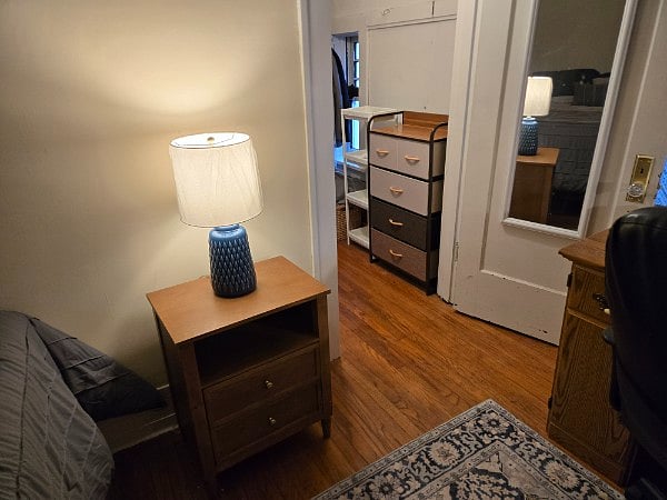 THE IN-LAW ($800) - This is a small room but it has a full-size bed, walk-in closet, workstation and shelves. We have done everything to make it cozy and practical. The bed has a storage headboard, the walk-in closet has a dresser and hooks and shelves. There is a credenza and full length mirror, room-darkening shades. The room is freshly painted. Full bath is in the hall and there are two additional half-baths in the house. 13 ft 5" X 9 ft (circa 121 sq ft).