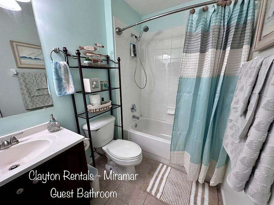 Main Bathroom features a full tub and shower, with closet storage for linens. Towels and starter products provided to include hair dryer and styling products.