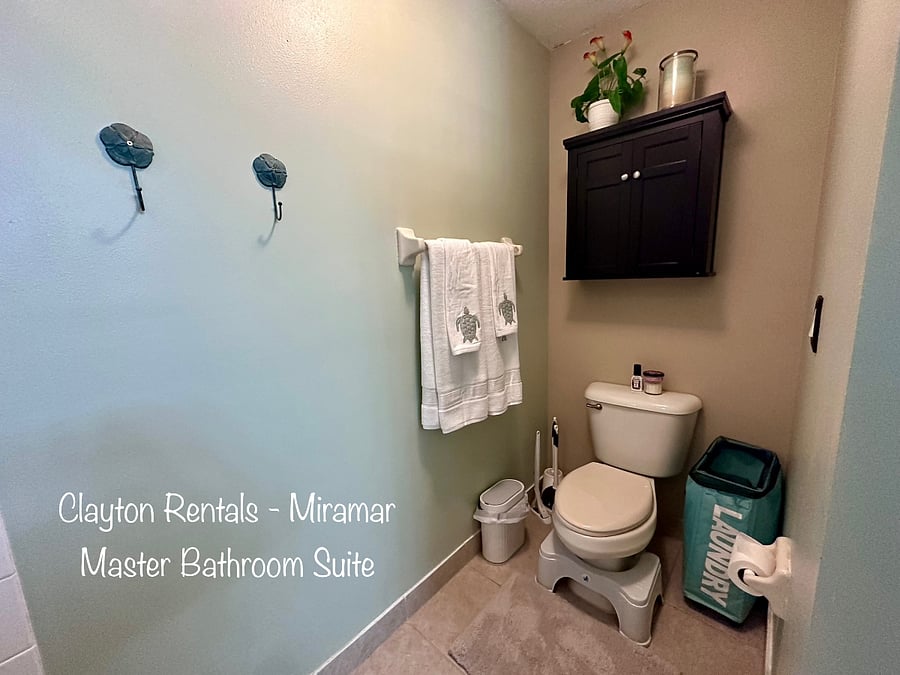 The master bathroom includes a tub, a shower, and a double sink. Toilet area is private.