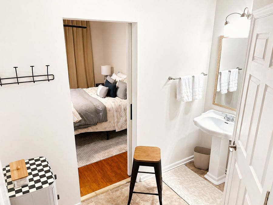 Master bathroom. En suite to room. Single sink, shower and toilet. Storage cabinet, hooks and plenty of towels. Movable stool for makeup application at the mirror.