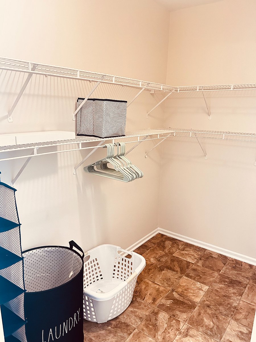 Master bedroom closet. Laundry baskets, hangers, shoe storage.