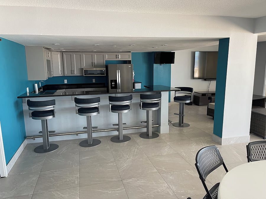 Partial view of reservable recreation room for events and parties. Full kitchen. This area is at pool level, off the pool deck with ocean view.