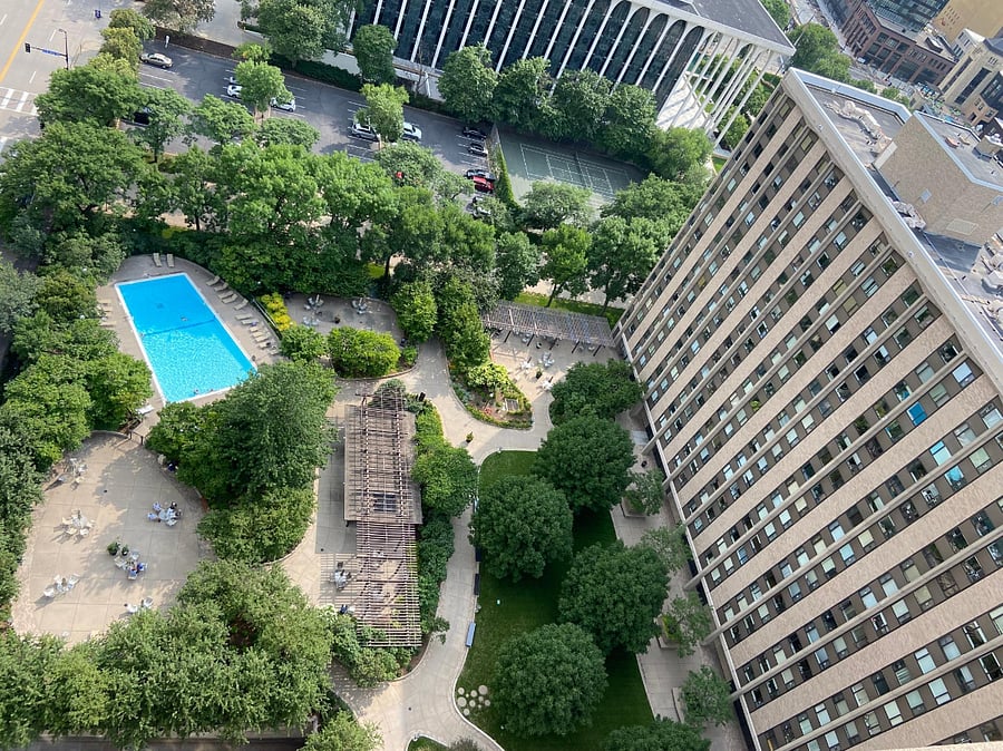Courtyard with multiple BBQs, large size pool, tennis court, and outdoor parking.