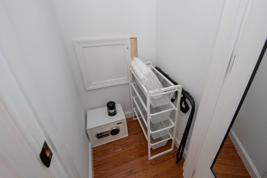 small safe included in the bedroom closet, luggage rack, extra storage rack + hangers, both regular and pant