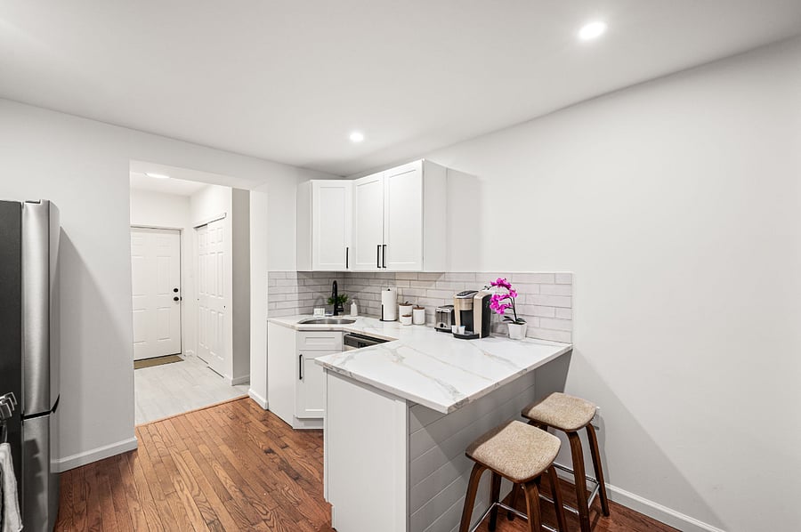 full kitchen with seating for 2 Includes dishwasher, microwave, oven, toaster, blender, Keurig coffee maker, pots, pans, bakeware, plates, utensils, glasses, mugs, towels.