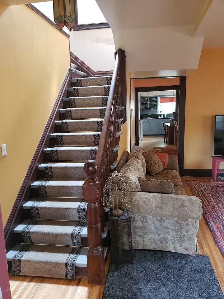 Stairs plus entryway to dining room then kitchen